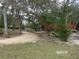 Gravel driveway and grassy area with trees at 17935 Se 10Th Pl, Silver Springs, FL 34488
