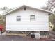 Rear view of an elevated home with simple design and AC unit at 17935 Se 10Th Pl, Silver Springs, FL 34488