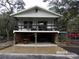 Front view of an elevated home with a covered porch and parking underneath at 17935 Se 10Th Pl, Silver Springs, FL 34488