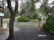 Gravel driveway and front yard with oak trees at 17935 Se 10Th Pl, Silver Springs, FL 34488