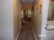 Long hallway with carpet and view into living area at 17935 Se 10Th Pl, Silver Springs, FL 34488
