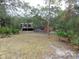Elevated home with a deck, surrounded by lush greenery at 17935 Se 10Th Pl, Silver Springs, FL 34488