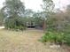 Elevated home with a deck, surrounded by lush greenery at 17935 Se 10Th Pl, Silver Springs, FL 34488