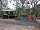 Elevated home with a deck and a large shipping container at 17935 Se 10Th Pl, Silver Springs, FL 34488