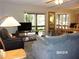 Living room with access to a screened porch and dining area at 17935 Se 10Th Pl, Silver Springs, FL 34488