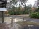 Small patio area next to house with wooden railing at 17935 Se 10Th Pl, Silver Springs, FL 34488