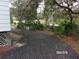 View of the side yard with trees and gravel at 17935 Se 10Th Pl, Silver Springs, FL 34488