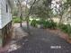 Gravel driveway and side yard with mature trees at 17935 Se 10Th Pl, Silver Springs, FL 34488