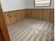 Simple bedroom with wood paneling and carpet at 1855 Ne 23Rd St, Ocala, FL 34470