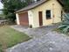 Detached garage with brown doors and side door at 1855 Ne 23Rd St, Ocala, FL 34470