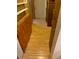 Hallway with wood flooring and built-in wooden cabinets and shelving at 1855 Ne 23Rd St, Ocala, FL 34470