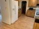 View of kitchen with wood cabinets, laminate flooring, and a white refrigerator at 1855 Ne 23Rd St, Ocala, FL 34470