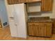 Kitchen features wood cabinets, laminate flooring, and white appliances at 1855 Ne 23Rd St, Ocala, FL 34470