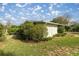 Detached shed in backyard with green hedges at 1918 Ne 9Th St, Ocala, FL 34470