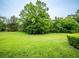 Large backyard with lush green grass and mature trees at 1945 Sw 40Th Pl, Ocala, FL 34471