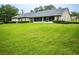 House exterior showcasing a large backyard and screened porch at 1945 Sw 40Th Pl, Ocala, FL 34471