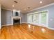 Spacious living room with hardwood floors, fireplace, and access to patio at 1945 Sw 40Th Pl, Ocala, FL 34471