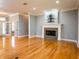 Living room with hardwood floors, fireplace, and built-in shelving at 1945 Sw 40Th Pl, Ocala, FL 34471