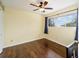 Well-lit bedroom featuring wood-look floors and ceiling fan at 21959 Nw 6Th St, Dunnellon, FL 34431