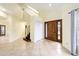 Bright and spacious entryway with tile floor and wooden staircase at 21959 Nw 6Th St, Dunnellon, FL 34431