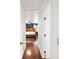 Bright hallway with hardwood floors leading to a bedroom at 21959 Nw 6Th St, Dunnellon, FL 34431