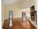 Living room with hardwood floors, fireplace and large windows at 21959 Nw 6Th St, Dunnellon, FL 34431