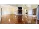 Spacious living room with hardwood floors and a stone fireplace at 21959 Nw 6Th St, Dunnellon, FL 34431