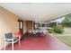 Covered patio with picnic table, red tile flooring, and pool view at 21959 Nw 6Th St, Dunnellon, FL 34431