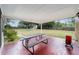 Red tile patio with picnic table and backyard view at 21959 Nw 6Th St, Dunnellon, FL 34431