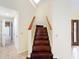 Elegant dark wood staircase with light walls at 21959 Nw 6Th St, Dunnellon, FL 34431