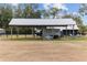 Metal roofed storage structure with parking for a small trailer at 21959 Nw 6Th St, Dunnellon, FL 34431