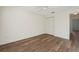 Well-lit bedroom with wood-look floors and double doors at 2427 Due West Dr, The Villages, FL 32162