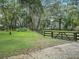 Spacious backyard with a black fence and lush green grass at 10502 Se 29Th Ave, Ocala, FL 34480