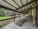 Covered walkway between stables offering shade and shelter at 10502 Se 29Th Ave, Ocala, FL 34480