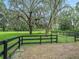 Grass paddock with black rail fencing, ideal for horses at 10502 Se 29Th Ave, Ocala, FL 34480