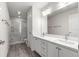Elegant bathroom with dual vanity, quartz countertop and a shower at 3321 Sw 153Rd Place Rd, Ocala, FL 34473