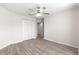 Bedroom with wood-look floors, double doors, and ceiling fan at 3321 Sw 153Rd Place Rd, Ocala, FL 34473