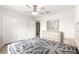Bedroom with ceiling fan, dresser, and double-door closet at 3321 Sw 153Rd Place Rd, Ocala, FL 34473