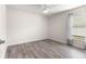 Spacious bedroom featuring wood-look floors and a large window at 3321 Sw 153Rd Place Rd, Ocala, FL 34473
