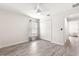 Well-lit bedroom with wood-look floors, double doors, and window at 3321 Sw 153Rd Place Rd, Ocala, FL 34473