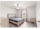 Bedroom with ceiling fan, double doors, and light wood furniture at 3321 Sw 153Rd Place Rd, Ocala, FL 34473