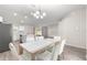 Open concept dining area with wood-look flooring and chandelier at 3321 Sw 153Rd Place Rd, Ocala, FL 34473