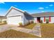 Home exterior view showcasing the garage and walkway at 3321 Sw 153Rd Place Rd, Ocala, FL 34473