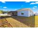House back view, showcasing a screened porch and a partially fenced backyard at 3321 Sw 153Rd Place Rd, Ocala, FL 34473