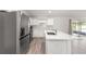 Modern kitchen with a large island and stainless steel refrigerator at 3321 Sw 153Rd Place Rd, Ocala, FL 34473