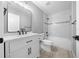 Updated bathroom with white vanity, bathtub, and gray tile at 3386 Sw 126Th Lane Rd, Ocala, FL 34473