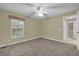 Spacious bedroom with ceiling fan and carpet at 4111 Se 2Nd Ln, Ocala, FL 34471