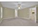 Large bedroom with carpet flooring and access to the kitchen at 4111 Se 2Nd Ln, Ocala, FL 34471