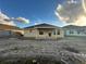 Tan house exterior with covered patio at 4477 Sw 90Th Pl, Ocala, FL 34476