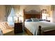 Main bedroom with king-size bed, plush bedding, and wood furniture at 4707 River Ridge Dr, Leesburg, FL 34748